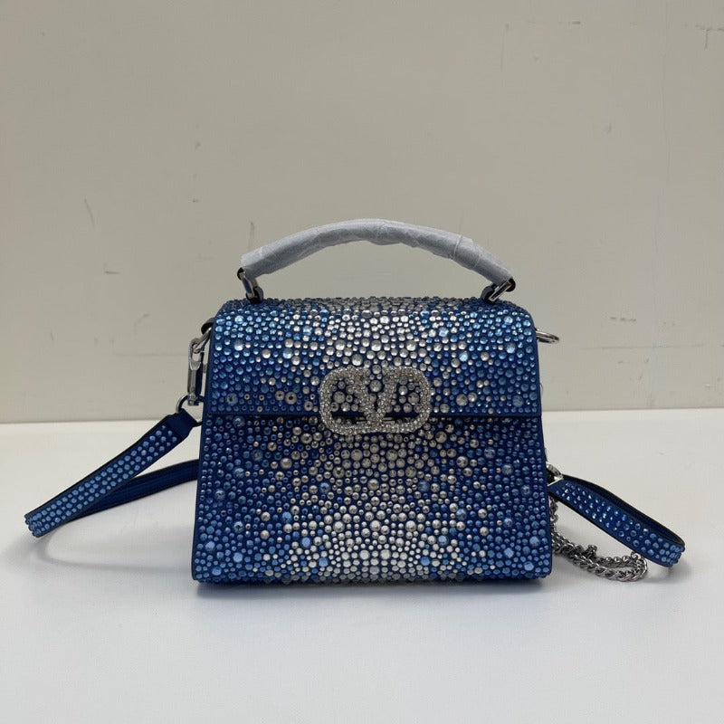 Bolso mini con lentejuelas de cristal y asa superior en azul y plata