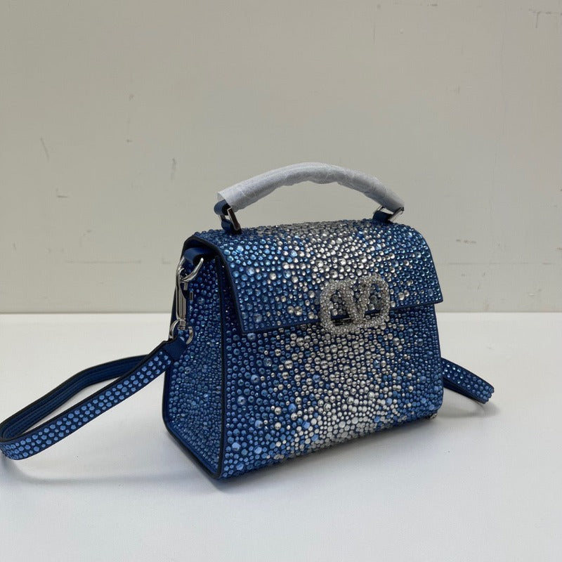 Bolso mini con lentejuelas de cristal y asa superior en azul y plata